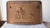 an antique cast-iron fireplace fireback featuring a raised relief scene of a horse-drawn cart with figures in a...