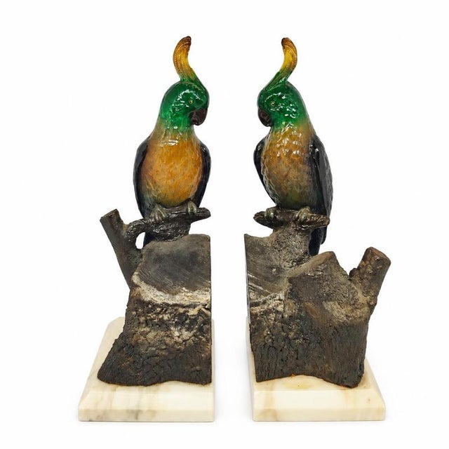 Pair of bookends with cockatoos. Pair of decorative bookends, symmetrically composed, representing two cockatoos perched...