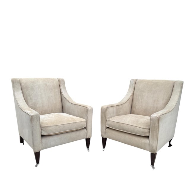 A pair of club chairs from renowned furniture maker George Smith. The Georgian chair is handmade in England and features a...