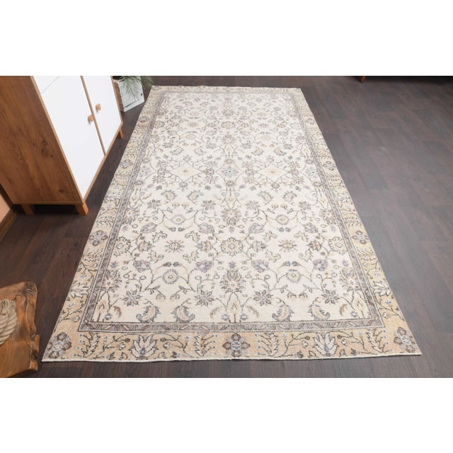 Vintage Turkish Hand-Knotted vintage rug is a semi-Vintage area rug.'70s Eastern region of Turkey's unique rug is...