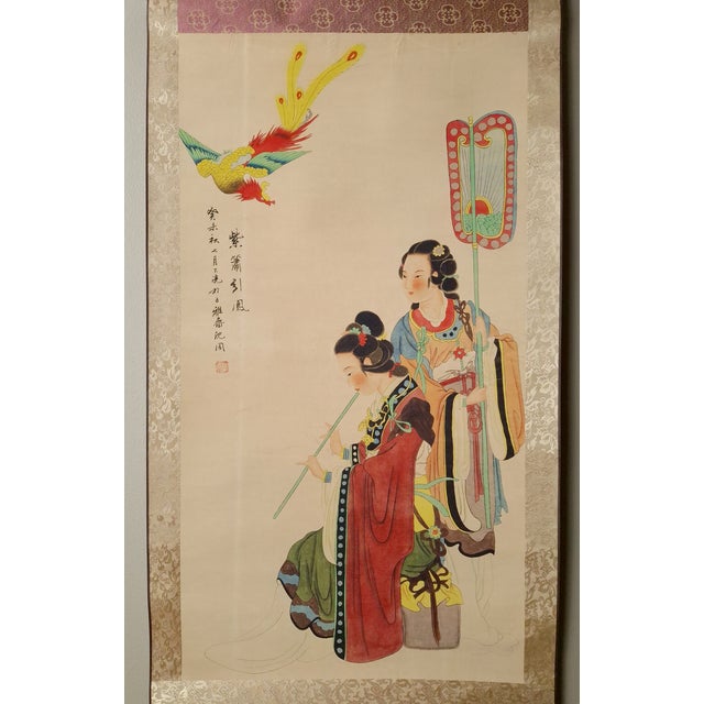 Chinese maidens and fenghuang scroll, freely drawn in colored inks on paper, mounted on a silk brocade nakamawashi in...