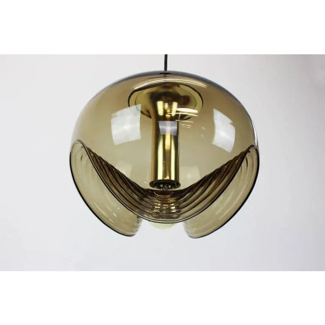 A special round biomorphic smoked glass pendant designed by koch & lowy for peill & putzler, manufactured in germany,...