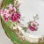 Decorate a holiday table with four lovely dessert plates. Gilded porcelain with emerald green border and adorned with pink...
