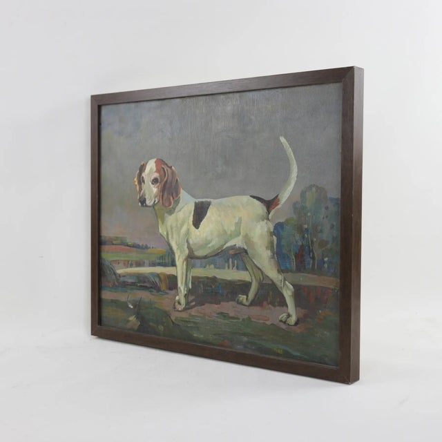 Capture the essence of countryside charm with this vintage oil painting depicting a poised hunting hound set against a...