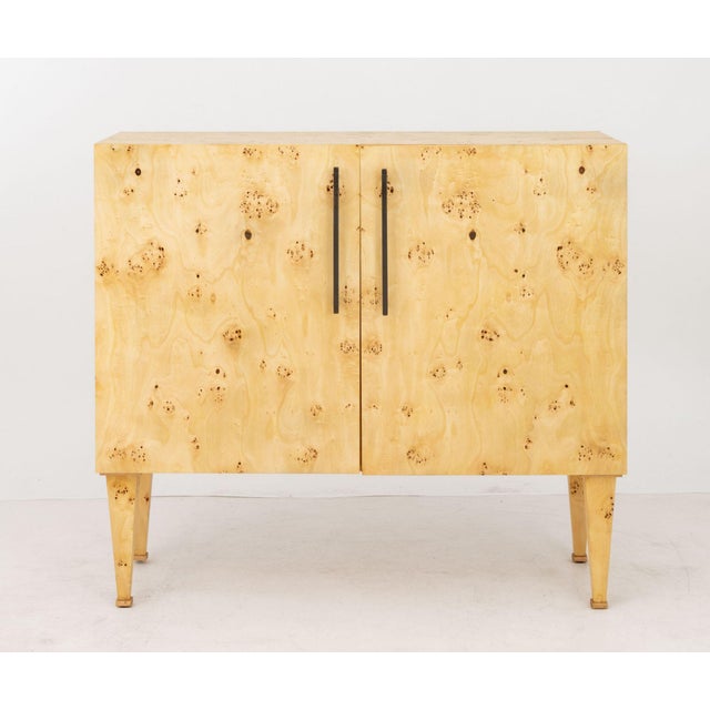 Contemporary Burl Poplar Cabinet, the two doors opening to two shelves on four tapered legs. 45" H x 50.25" W x 20" D....