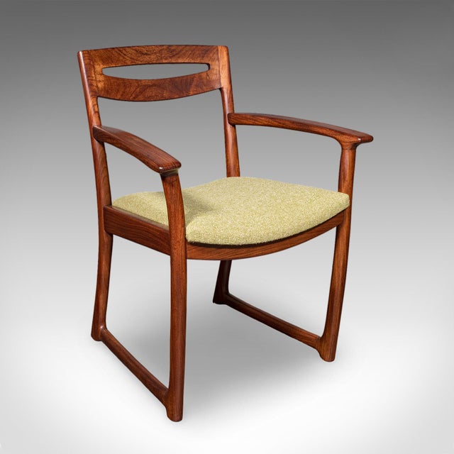 This is a pair of vintage side chairs. A Scottish, teak elbow seat with Scandinavian influence, dating to the mid 20th...