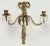 Pair of vintage French Empire brass three arm wall candle sconces with crystal drops. Featuring stunning timeless ribbon...