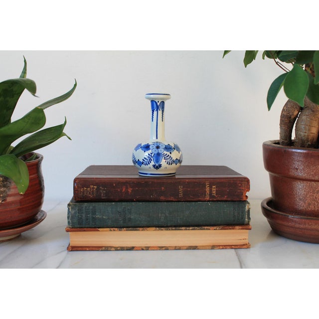 Vintage miniature ceramic blue and white bud vase by Delft. One chip on base. Pictured. Makers mark on bottom.