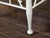 A vintage pair of English Egyptian Revival white painted wood Thebes stool from the mid 20th century, with slatted curving...