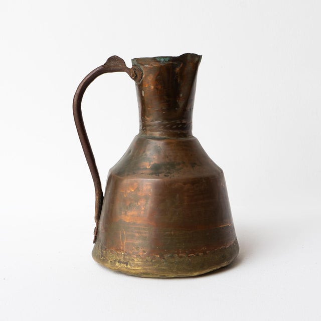 PRIMITIVE ANTIQUE JUG/EWER Handmade from a number of metals with a hand-hammered copper main body dovetailed with a brass...