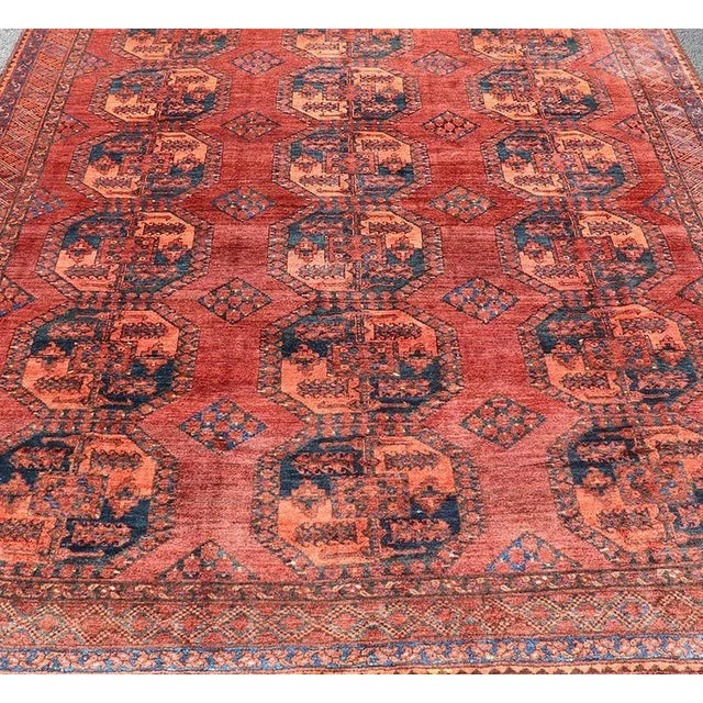 This Turkomen Ersari rug has been hand-knotted in the finest wool. The rug features a repeating Gul design throughout the...