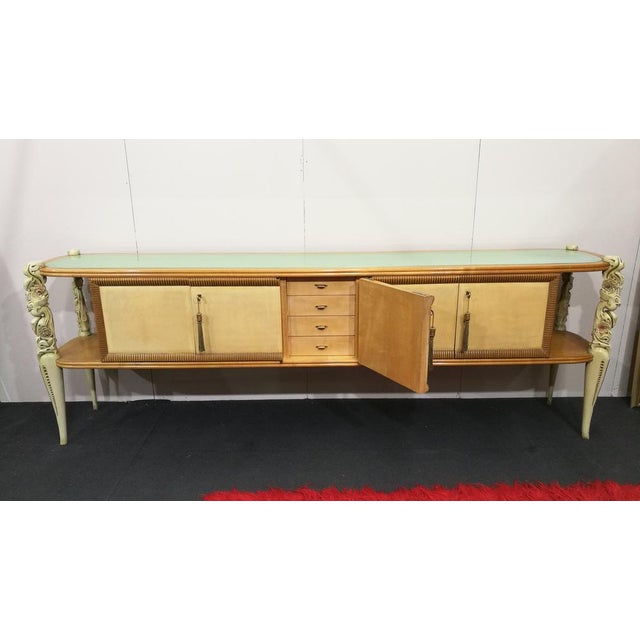 Rare sideboard by La Permanente Mobili Cantù, 1940s-50s. Wooden structure with parchment doors and finely carved legs. 130...