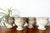 Set of four gray reconstituted stone planters, shaped like antique Medici vases. In very good condition, with a beautiful...