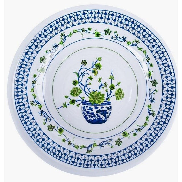 Elevate your dining experience with the Floral Cache Pot Melamine Charger. This exquisite collection features elegant blue...