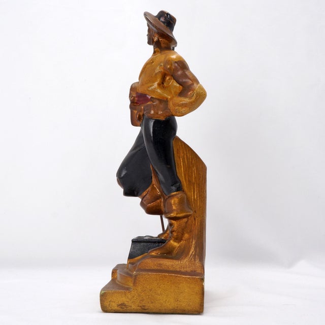 An oversized bookend featuring a swashbuckling pirate dressed in armor that was produced by the Armor Bronze company circa...