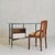 An Italian desk from the 1950s, attributed to Luigi Caccia Dominioni for Azucena, distinguished by a thick cast glass top...