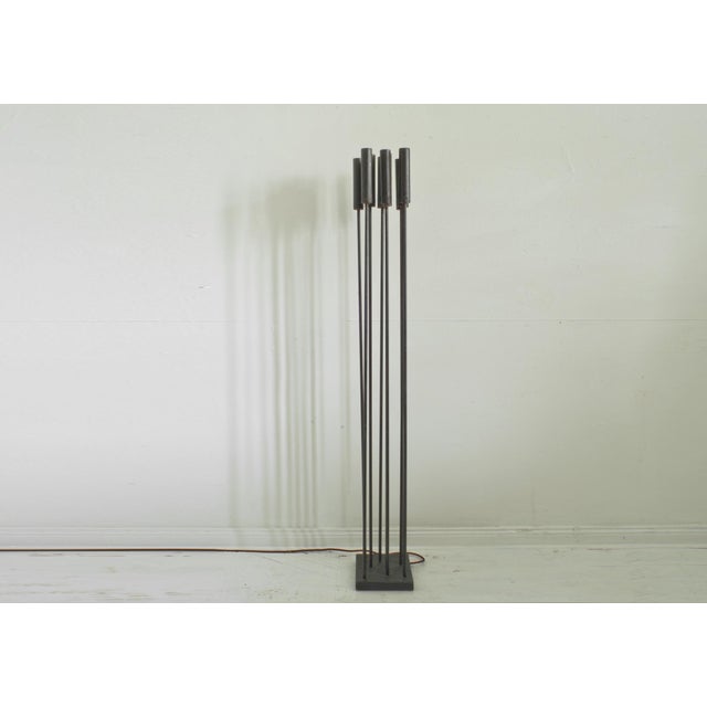Nine mysteriously downward-radiating, reed-like rods evoke a morning or evening atmosphere in the forest and create a...