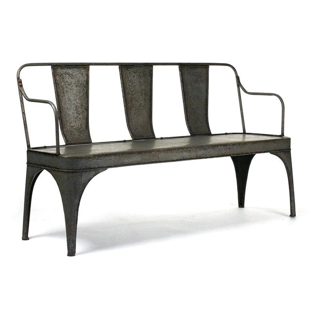 The Adrienne Iron Bench from Zentique is an industrial garden bench in rustic zinc-finished iron with a scrollwork back,...