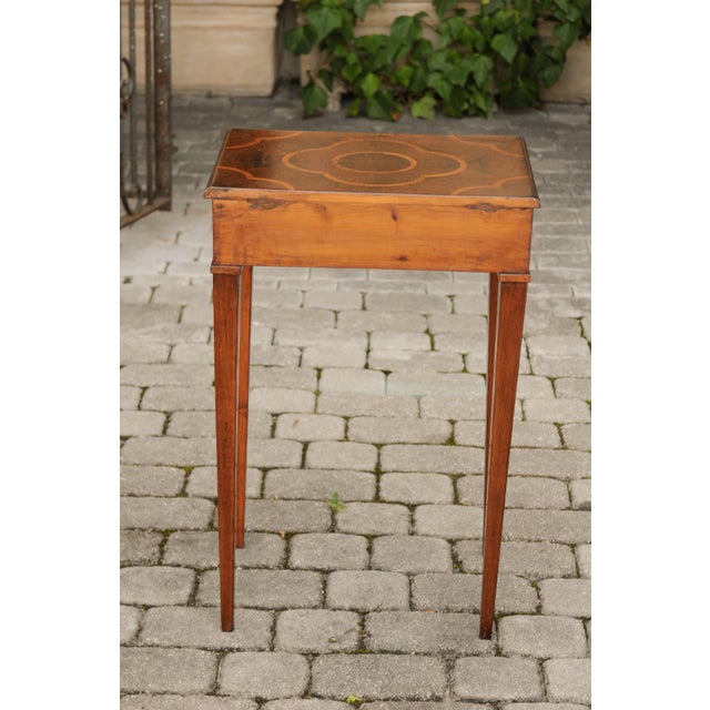 An Italian walnut side table from the early 19th century with oyster veneered top, quadrilobe inlay, single drawer and...