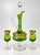 DESCRIPTION An exceptionally elegant seven-piece cordial service in brilliant emerald-green glass, distinguished by...