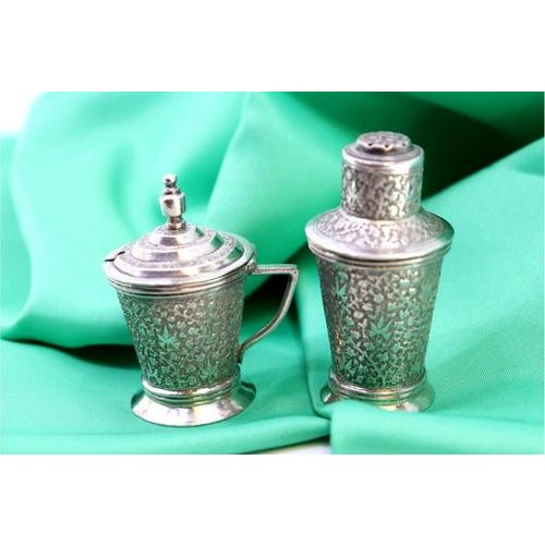 Salt and Pepper Shakers in Embossed Silver, Set of 2, in Very Good conditions. Designed from 2000 This piece has an...