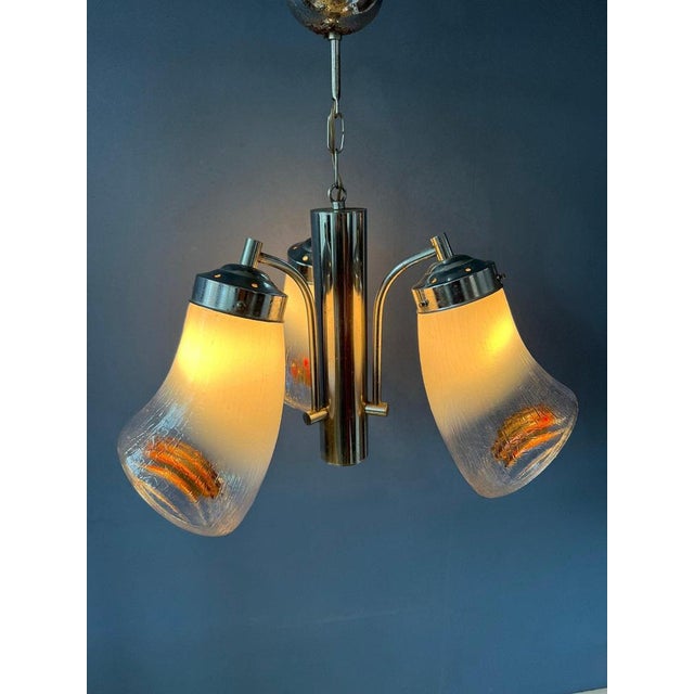 One of a kind murano glass chandelier with horn-like shades in the style of Mazzega. The lamps have three patterned glass...