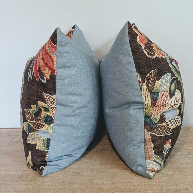 Lee Jofa Leyland Print pillows in tobacco colorway featuring brights corals and greens on a brown background. Softened...