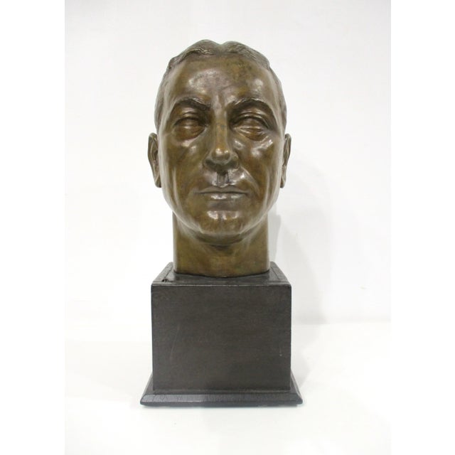 A finely detailed and very well crafted cast plaster bust of a distinguished mans head in a dark patina bronze tone which...