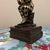 A charming and highly detailed vintage bookend depicting a Harlequin or Jester in a classic "Thinker" pose. Exuding the...