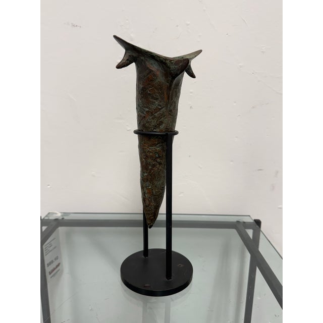 Design Plus Gallery presents a Sculptural Metal Vase on Stand. The vessel has an abstract tapered form with an angular,...