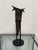 Design Plus Gallery presents a Sculptural Metal Vase on Stand. The vessel has an abstract tapered form with an angular,...