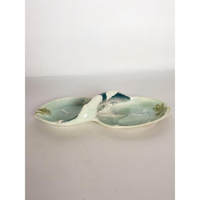 A charming Art Nouveau-style glazed ceramic catch-all, featuring two small dishes joined by a naturalistic sculpture of...