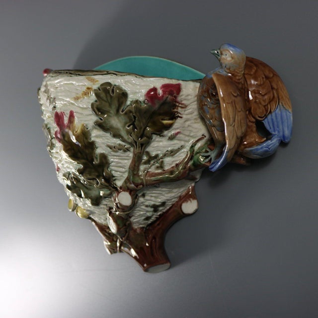 Wedgwood Argenta Majolica wall pocket which features a bird perched on the edge of a nest amongst oak leaves and branches...