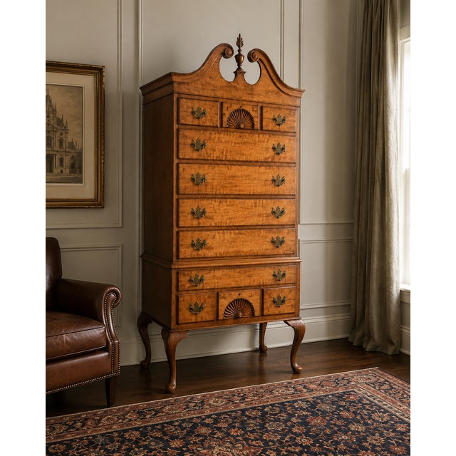 An elegant vintage Colonial Revival highboy featuring beautifully figured maple drawer fronts and classic Chippendale-...