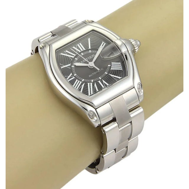 This is an authentic Cartier Roadster wrist watch, the case and band is crafted from solid stainless steel with a black...
