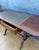 Spanish Regency Revival drop-leaf writing table crafted in solid wood, mid-20th century. Inspired by early 19th-century...