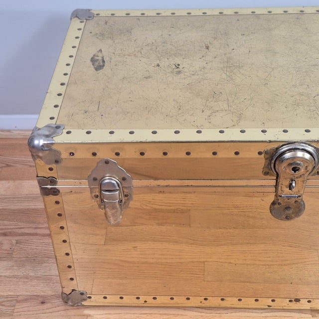 This is a vintage distressed brass clad trunk that is great for storing extra blankets or throw pillows. It would make a...