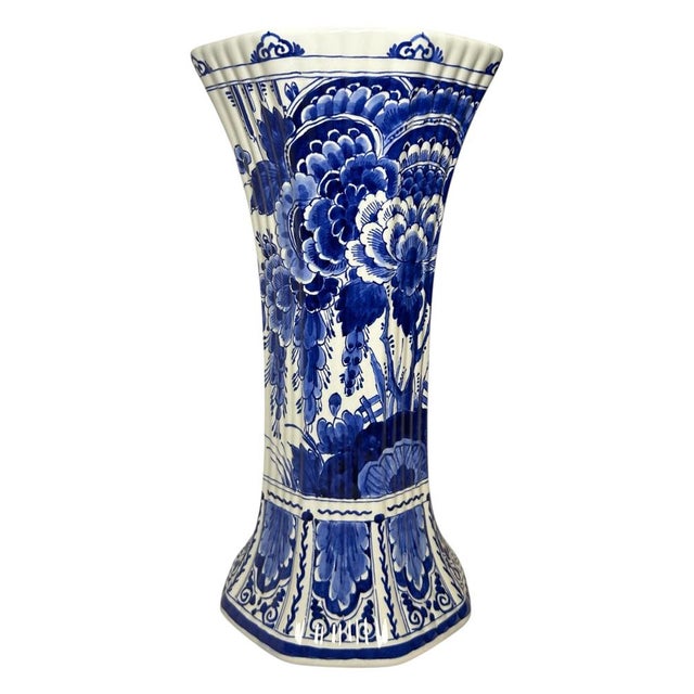 A large vintage royal delft trumpet vase by de porceleyne fles, hand-painted in a rich cobalt-blue palette. The vase has...