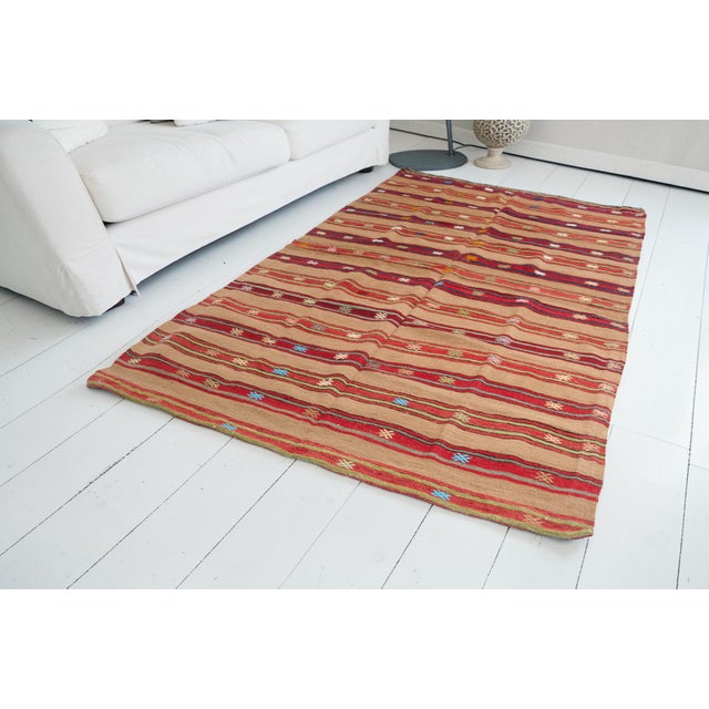 This is a vintage Turkish Oushak rug from the Mid 20th Century. The piece was hand-knotted.