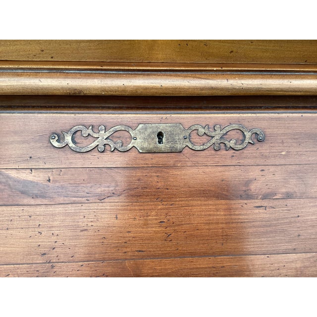 This handsome French cherry Secretary features a pull-down desk, an upper bookcase with glass doors, and 2 lower doors for...