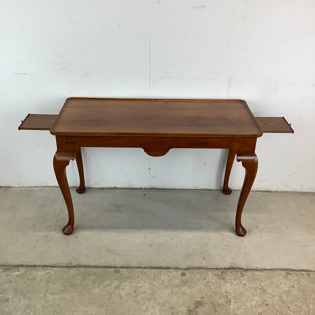Elegance and functionality come together in this Queen Anne-style cherry wood console table, reminiscent of fine...