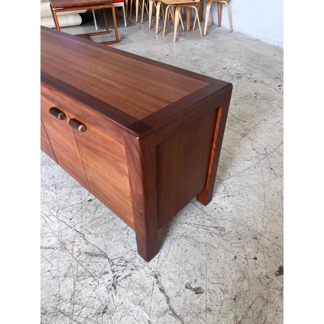 Newly refinished vintage credenza by Lou Hodges. This piece features beautiful two tone wood, chunky low profile design...