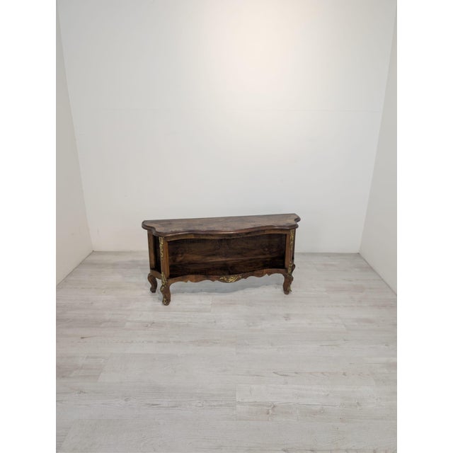 Antique Louis XV Style Chest of Drawers This piece of furniture features curved cabriole legs and a sinuous top and lower...