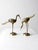 Pair of vintage brass crane sculptures featuring elegant silhouettes and detailed feather etching. One stands tall with an...