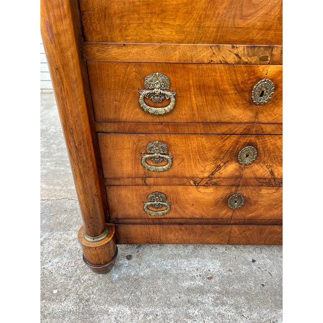Elegant French 19th-century Empire secretary crafted in richly figured burl walnut, featuring a striking black marble top,...