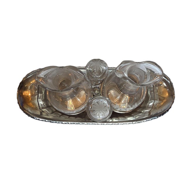 A beautiful set, comprising two engraved crystal cruets (oil and vinegar cruets) decorated with knotted garlands and stars...