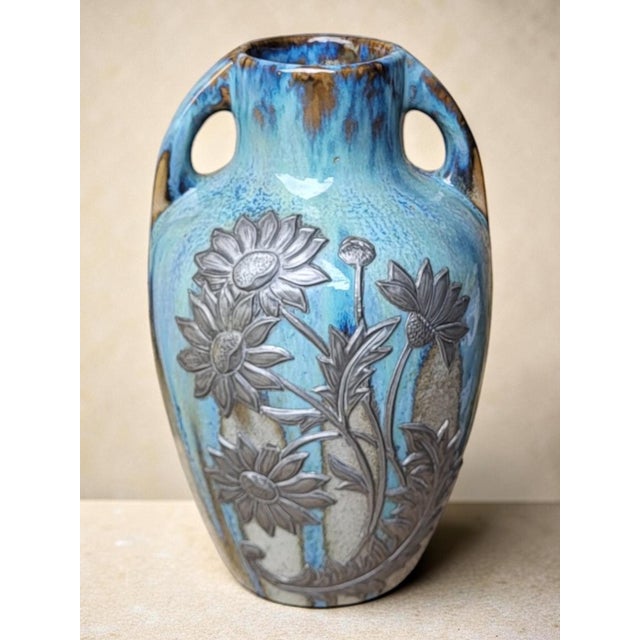 Stoneware vase adorned with applied pewter decoration of sunflowers. Crystallized glaze. Heraldic earthenware and marked...