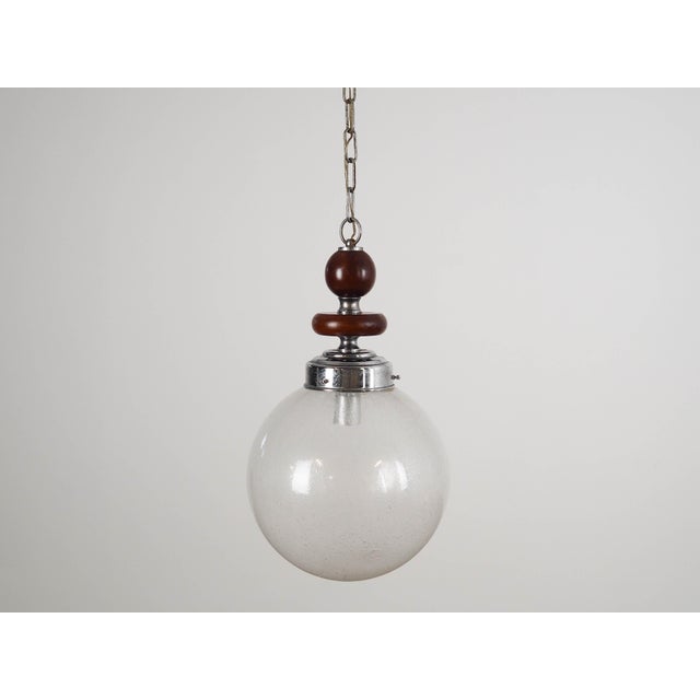 The lamp was made in the 1970s, Italian production. Made of metal, wood and Murano glass. The unique construction is not...