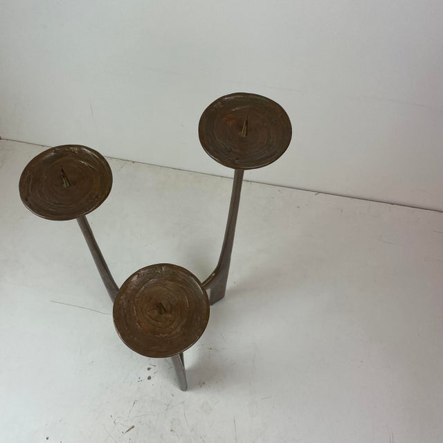 Sculptural Brutalist floor candle holder crafted in solid cast bronze, featuring three elongated organic branches that...