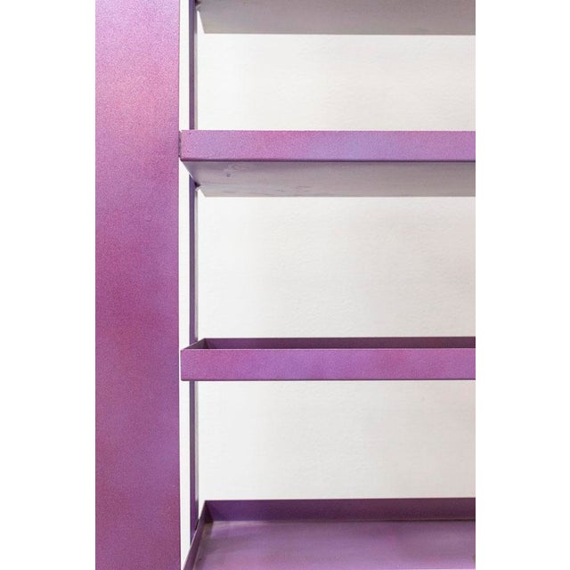 Original metal bookcase, powder-coated purple with shaded effects Equipped with 7 shelves, it has a shape that resembles...